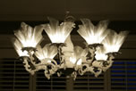 Chandeliers offer a more traditional solution, providing beauty and functional lighting over a table or large open area. Typically considered more of a decorative fixture, a chandelier adds an elegant touch which can brighten and warm up the room. All chandeliers are hand-made and when the light is dimmed, a soft, glowing atmosphere similar to candlelight is created.
